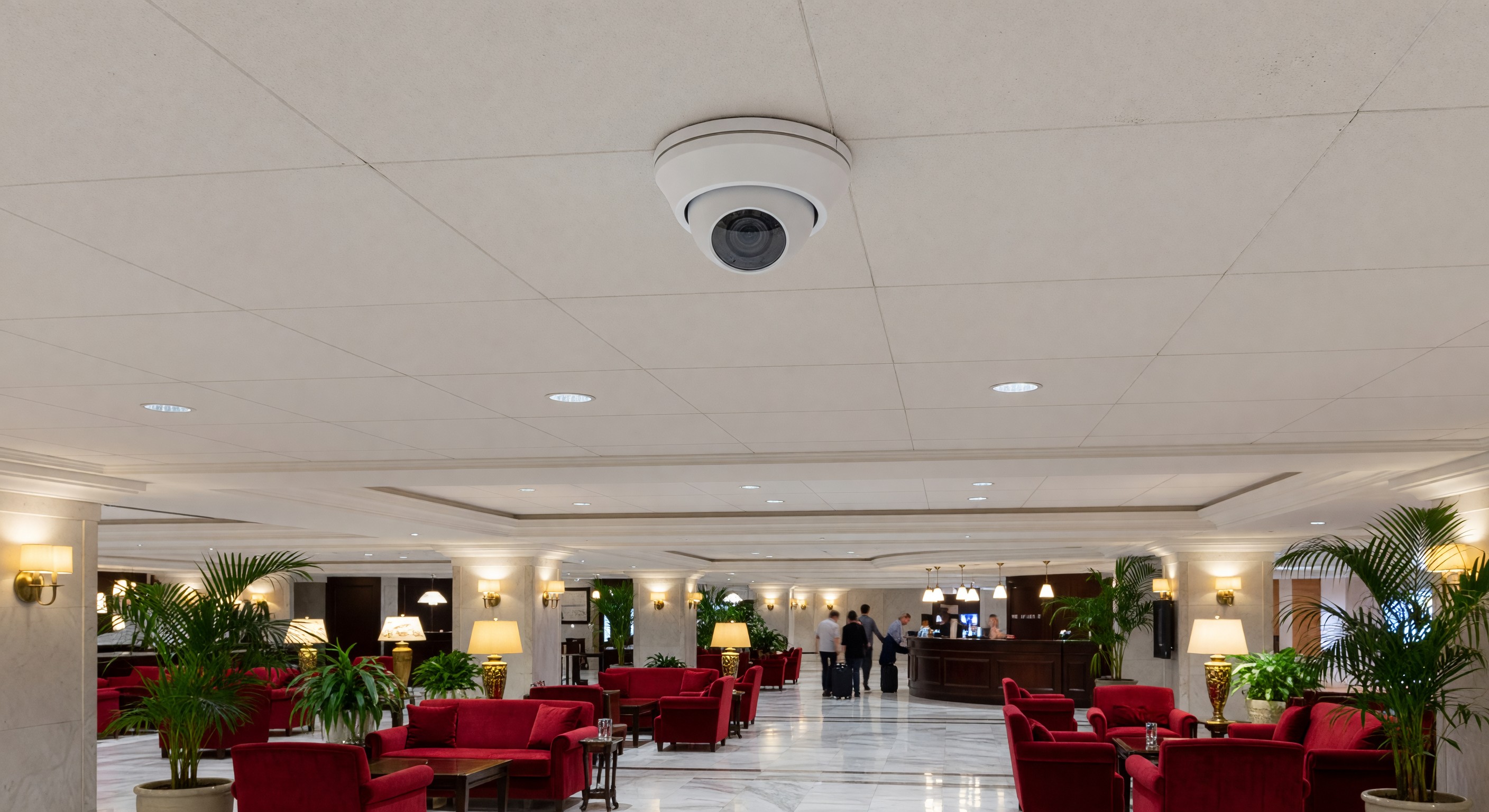 Security camera mounted in hotel lobby ceiling