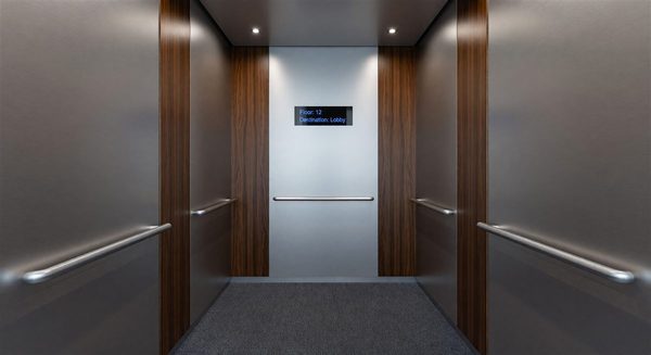 Modern hotel elevator cab interior with updated finishes and digital display