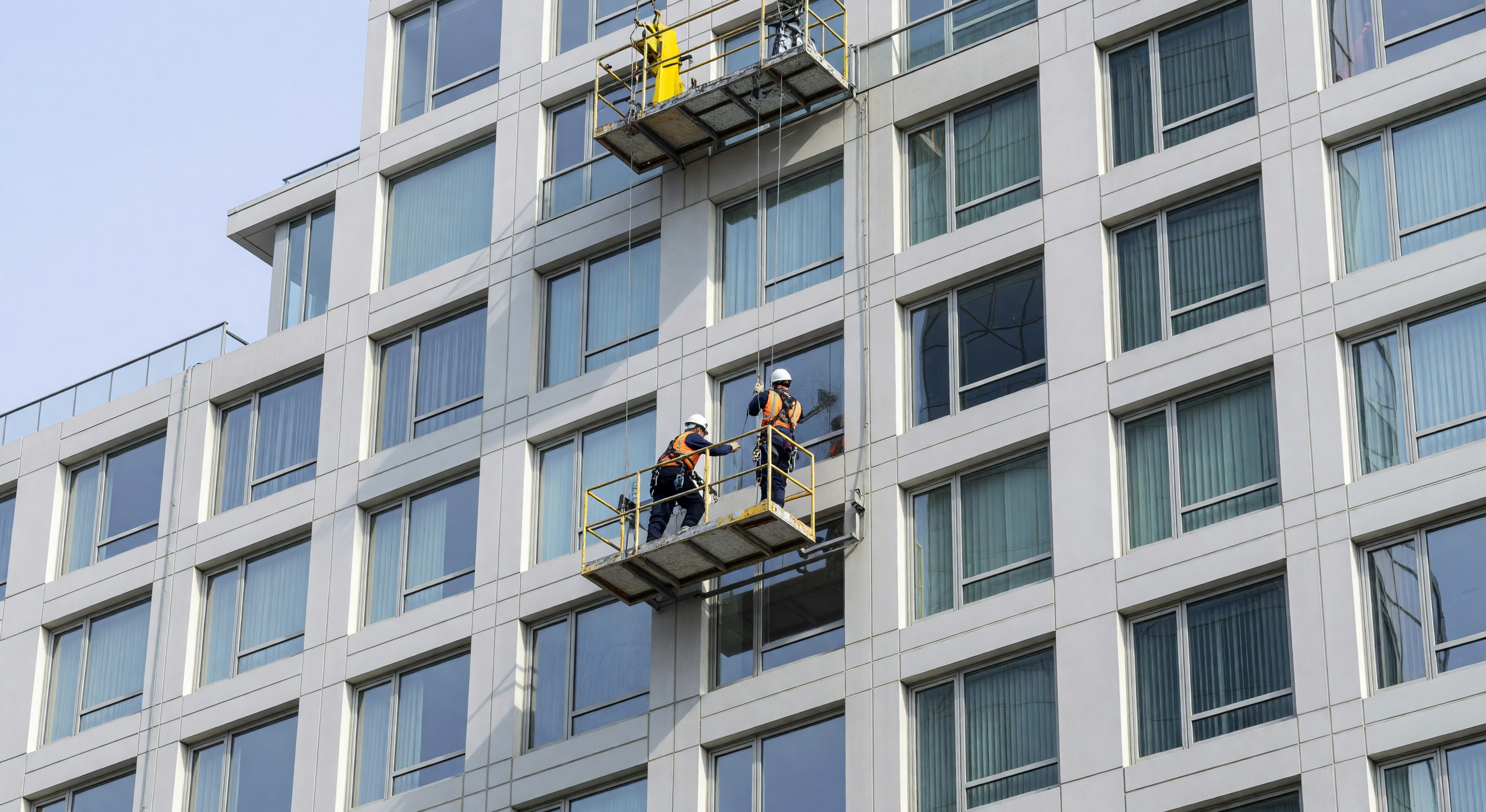 Hotel exterior facade with window cleaning equipment on high-rise building