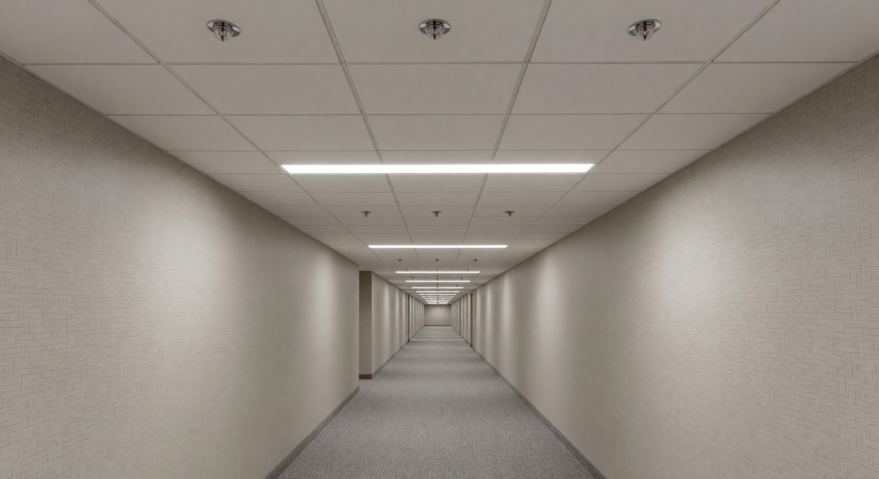 Hotel corridor with fire sprinkler heads installed in the ceiling