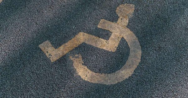 Accessible parking space with van-accessible access aisle at hotel parking facility