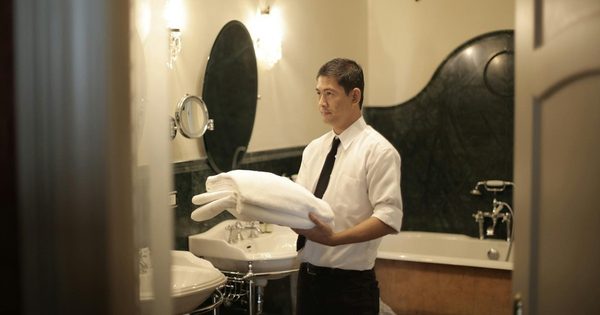 Hotel bathroom plumbing fixtures including showerhead and faucet requiring maintenance