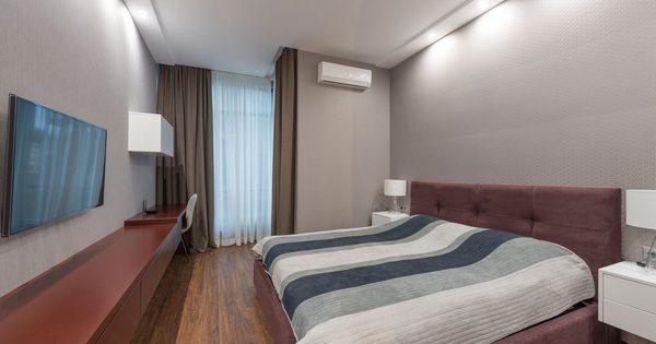 Hotel room with PTAC unit under window showing typical installation